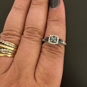 Quad enhanced blue and white diamond 3 stone ring